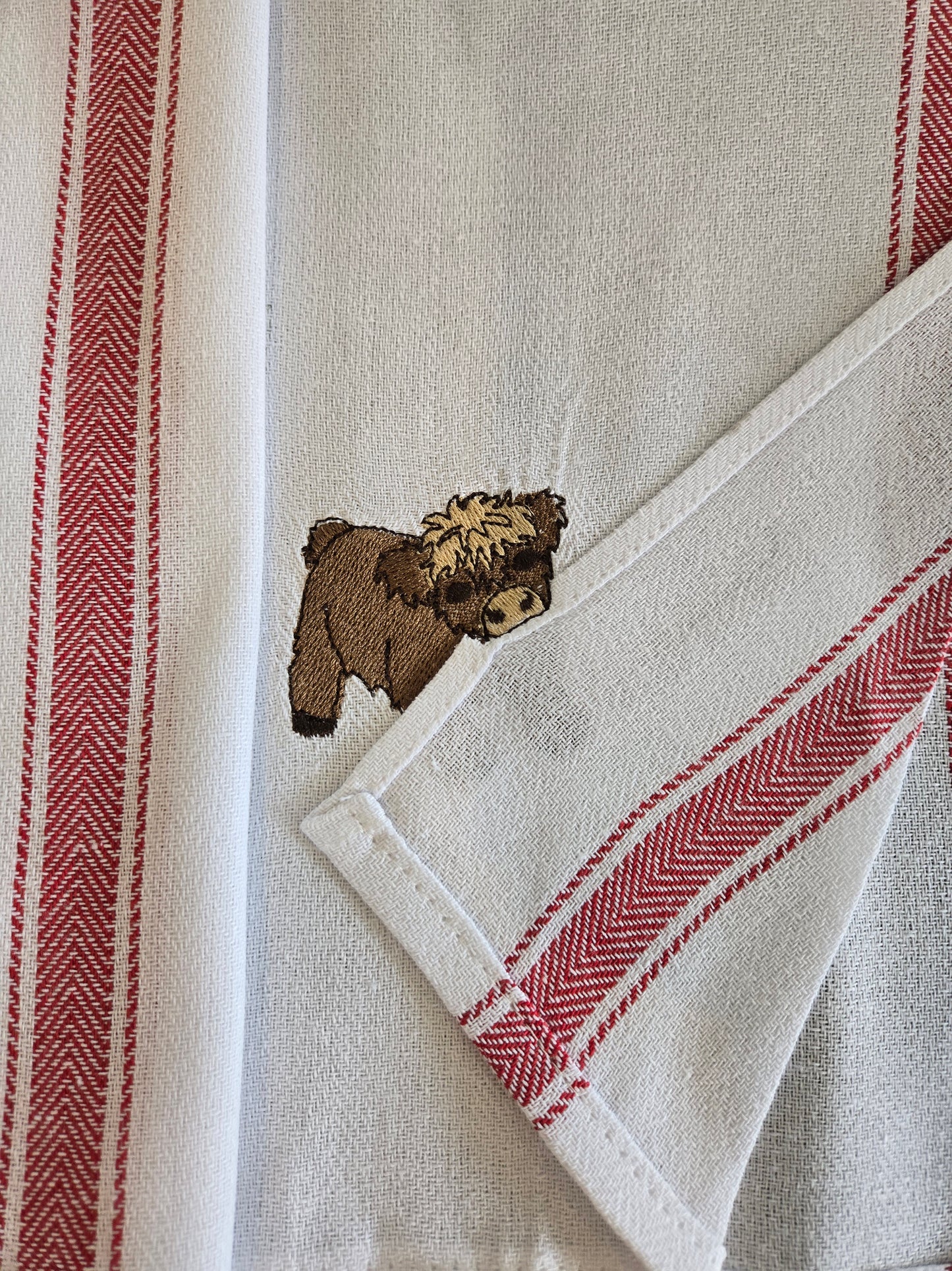 Cheeky Highland Cow Pet Thief embroidery design on white cotton red striped tea towel NZ