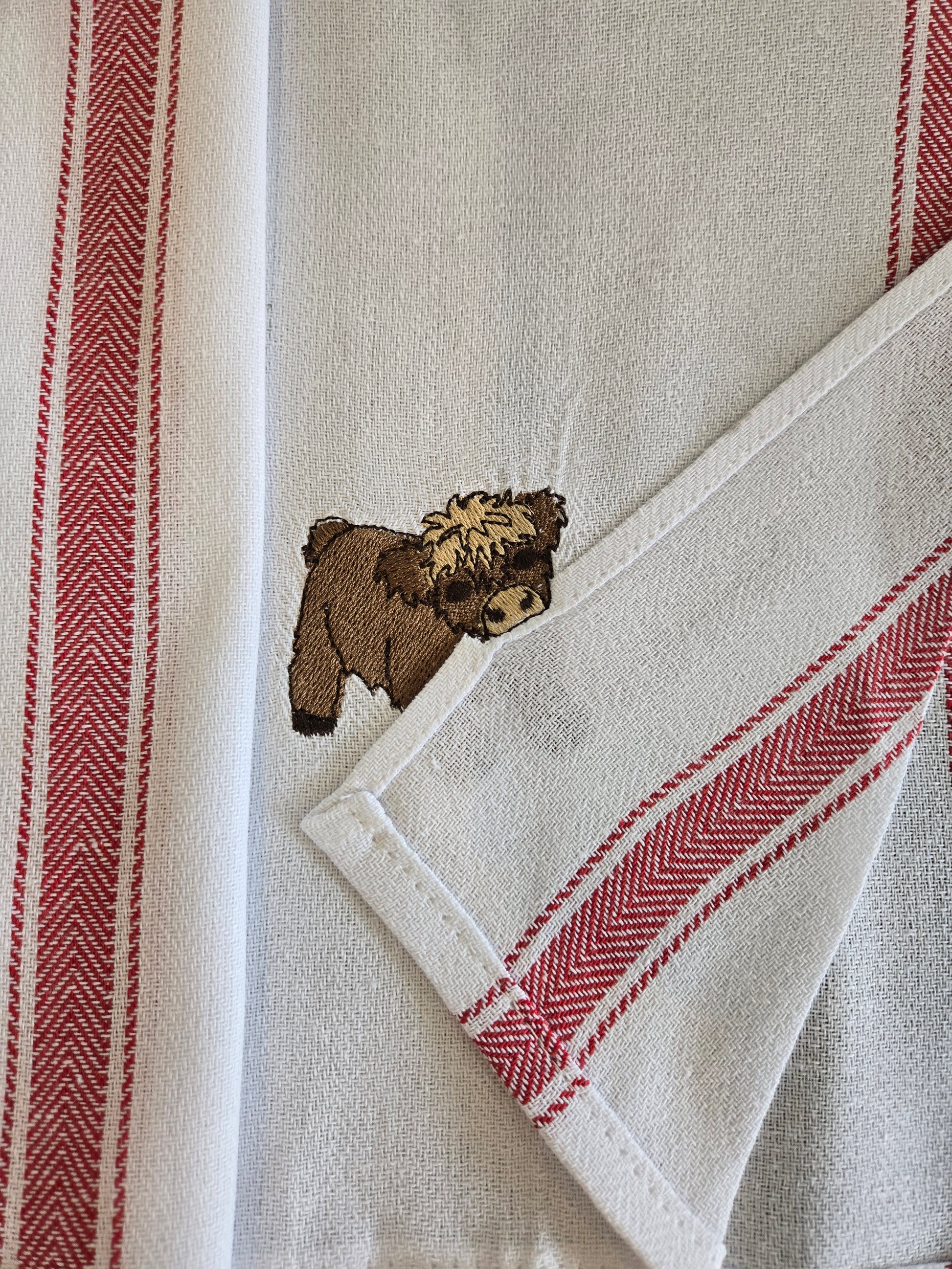 Cheeky Highland Cow Pet Thief embroidery design on white cotton red striped tea towel NZ