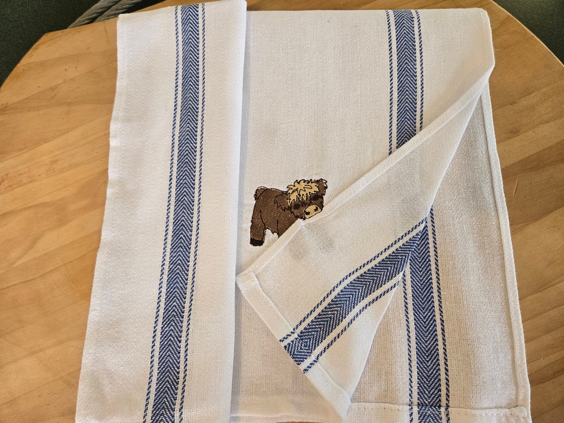 Cheeky Highland Cow Pet Thief embroidery design on white cotton striped tea towel NZ