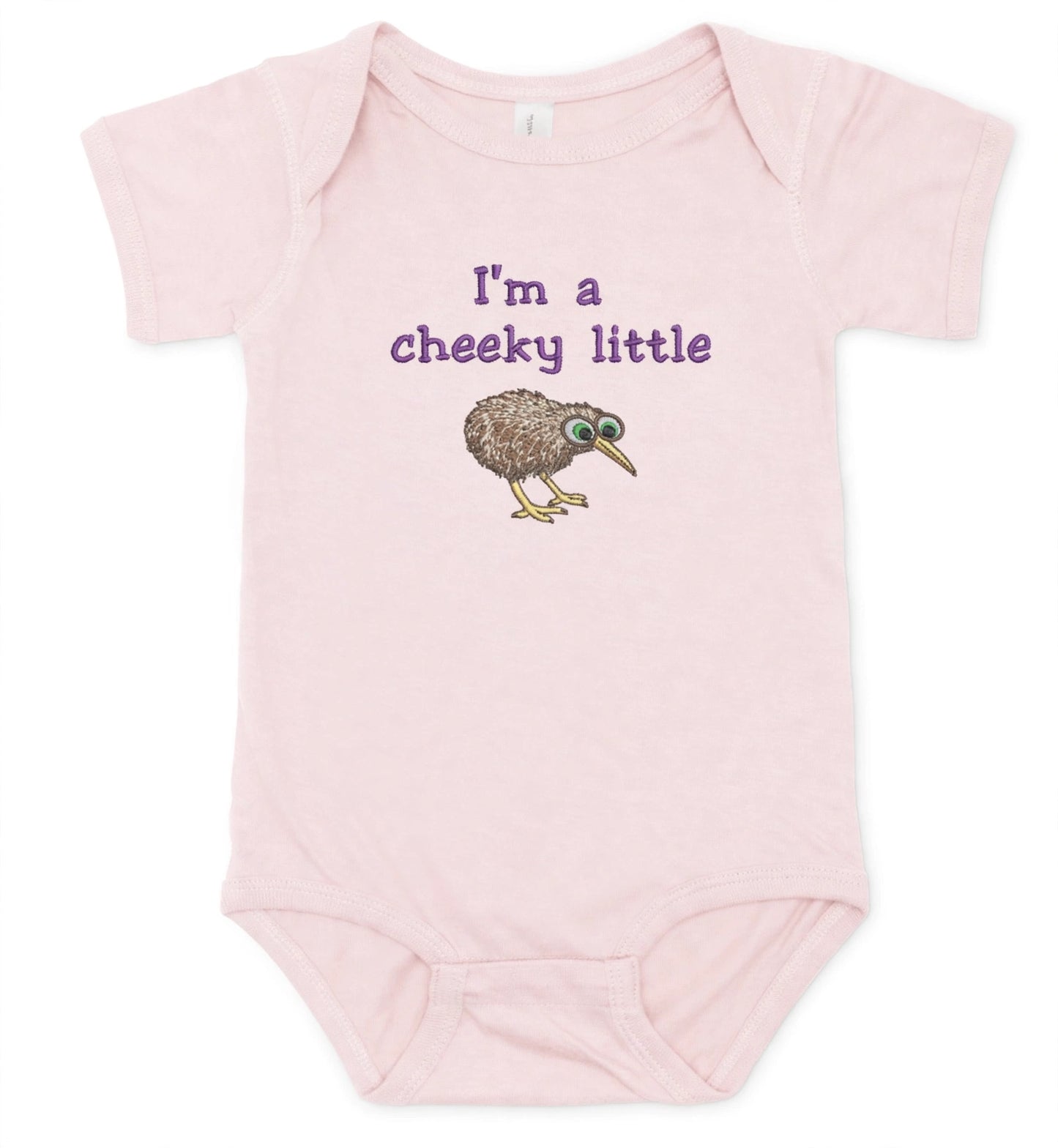 A light pink short-sleeve baby bodysuit featuring the purple text 'I'm a cheeky little' and a cartoon kiwi bird graphic on the front, displayed against a plain white background.