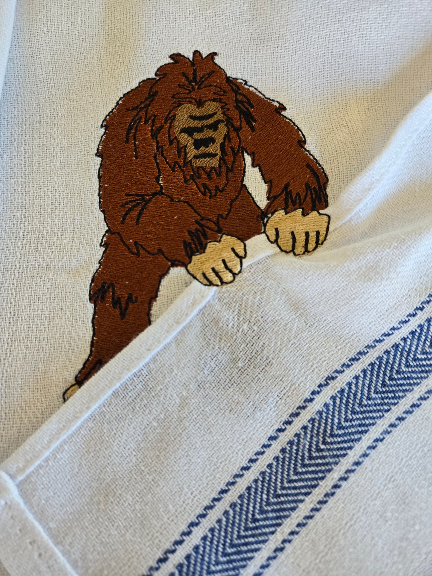 Funny Bigfoot Sasquatch pet thief embroidery design on white cotton striped tea towel NZ