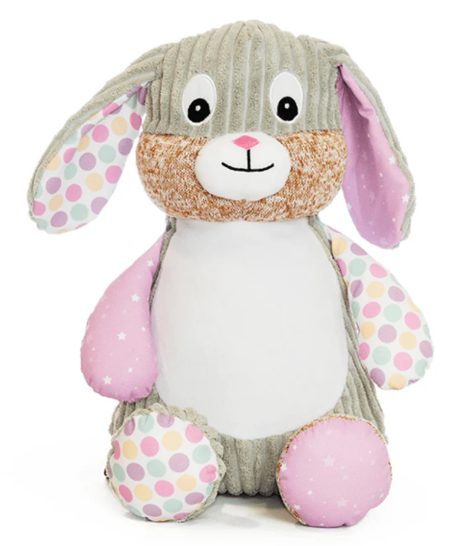 Plush toy rabbit with polka dot patterns on a white background