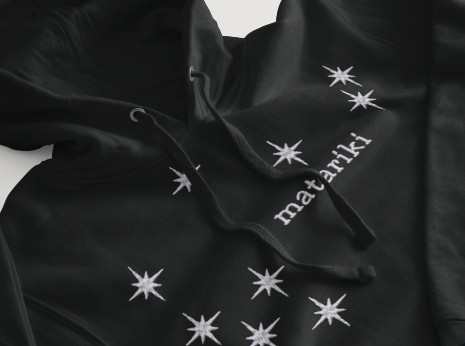 White embroidered Matariki star cluster design on a black family matching t-shirt and hoodie.