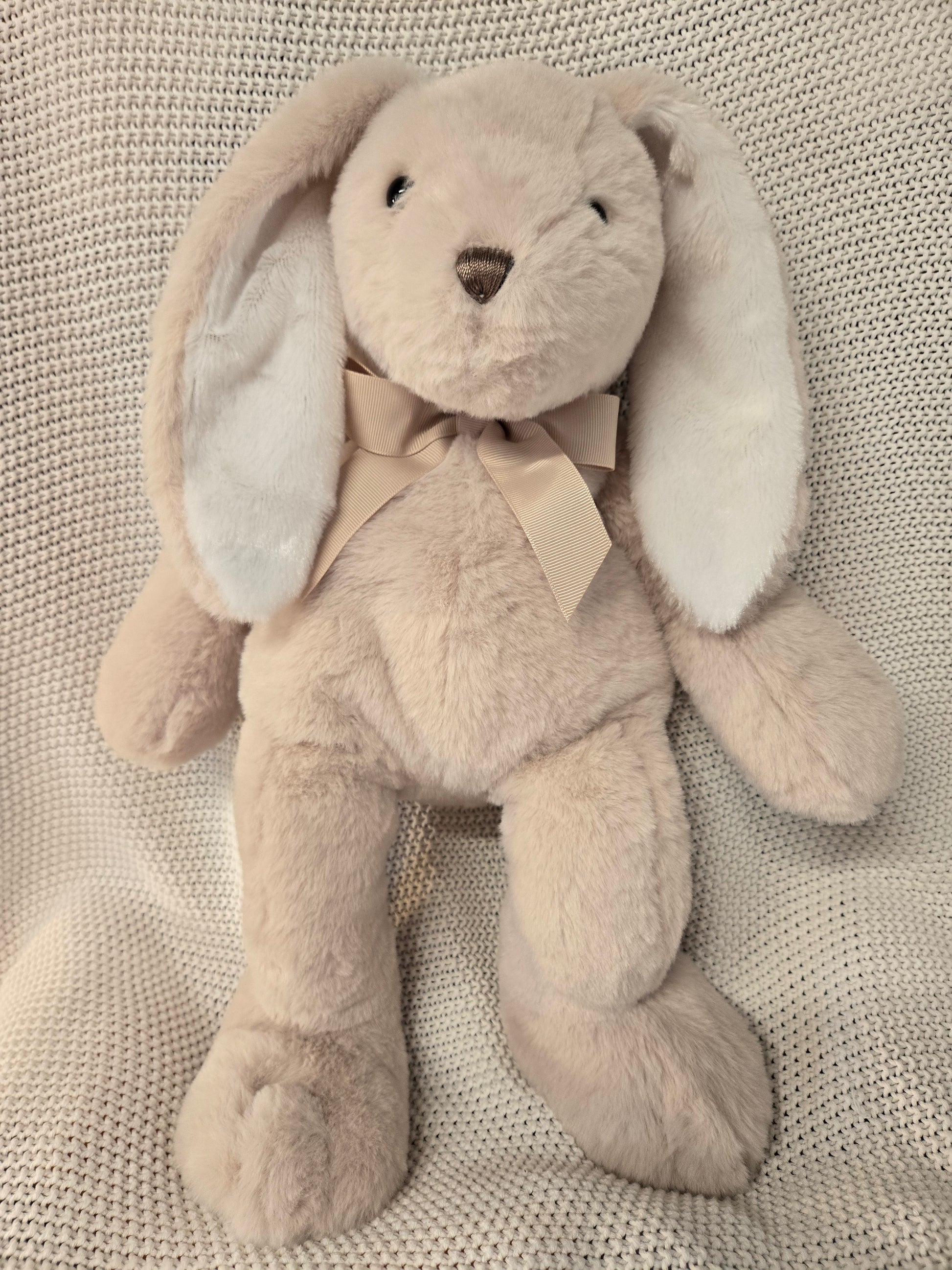 Plush toy resembling a seal on a textured surface